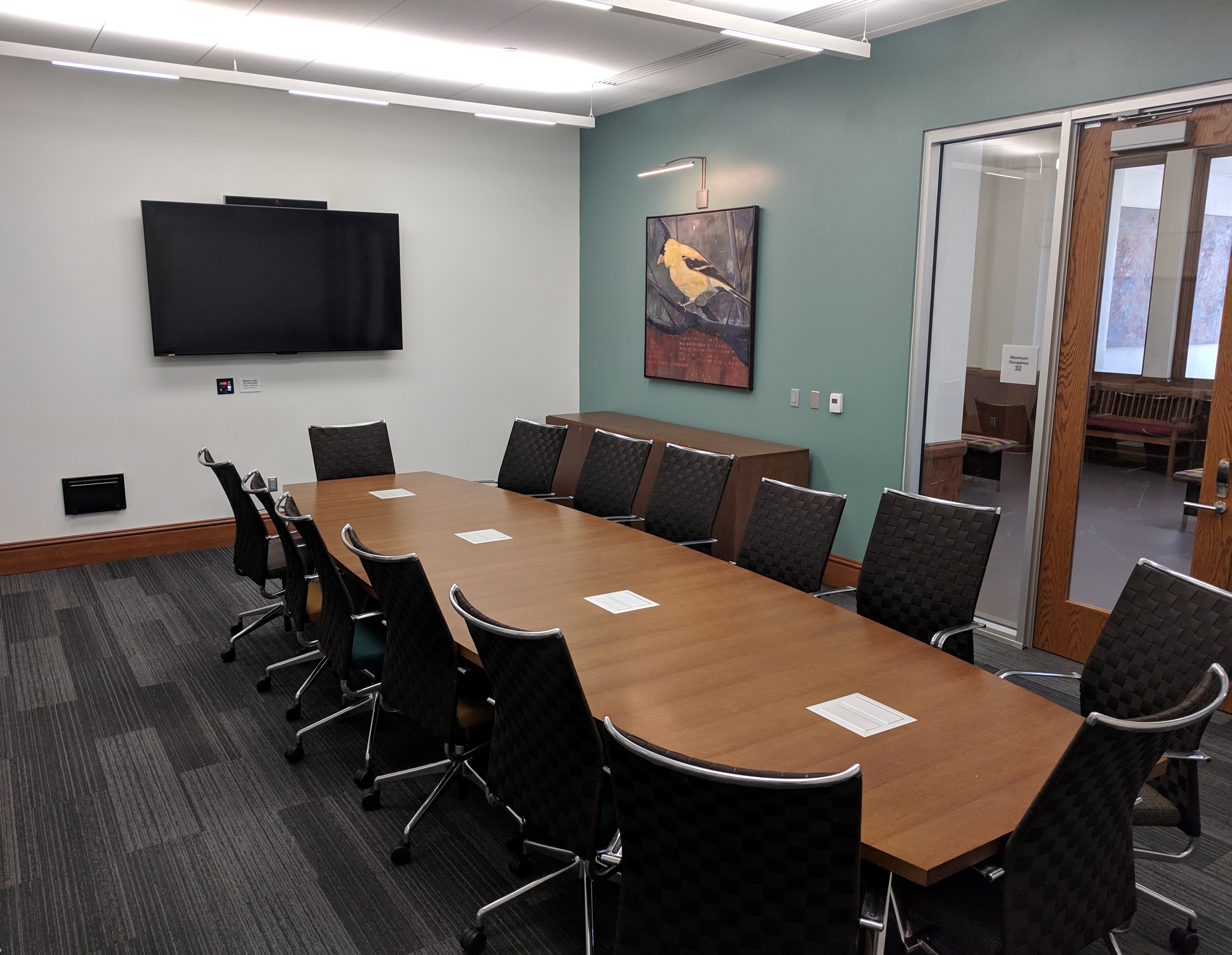 Dale H. Ross Boardroom with boardroom style seating and mounted tv screen