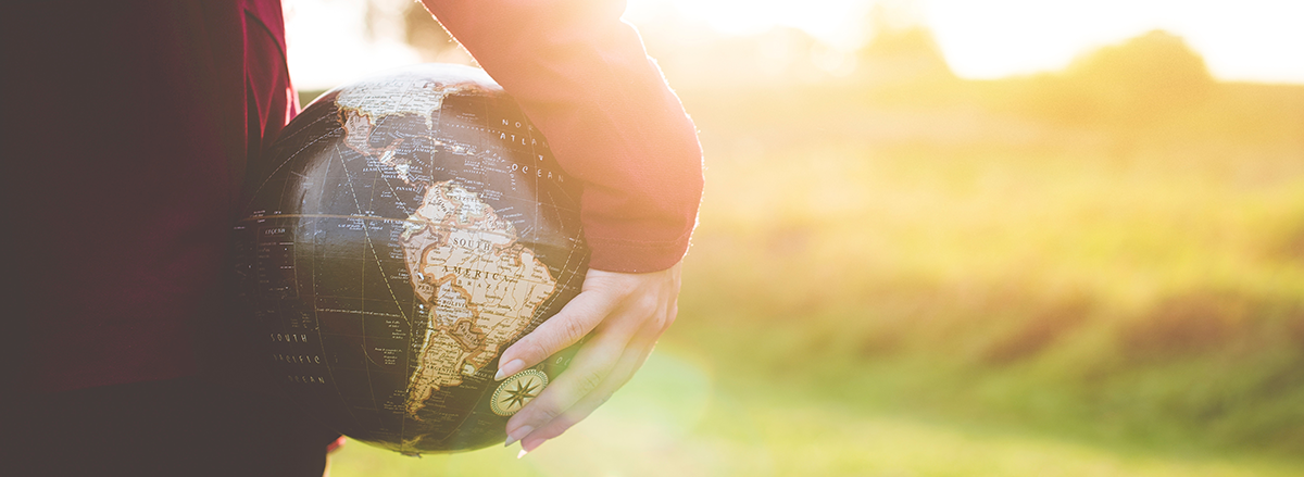 Woman holding small globe