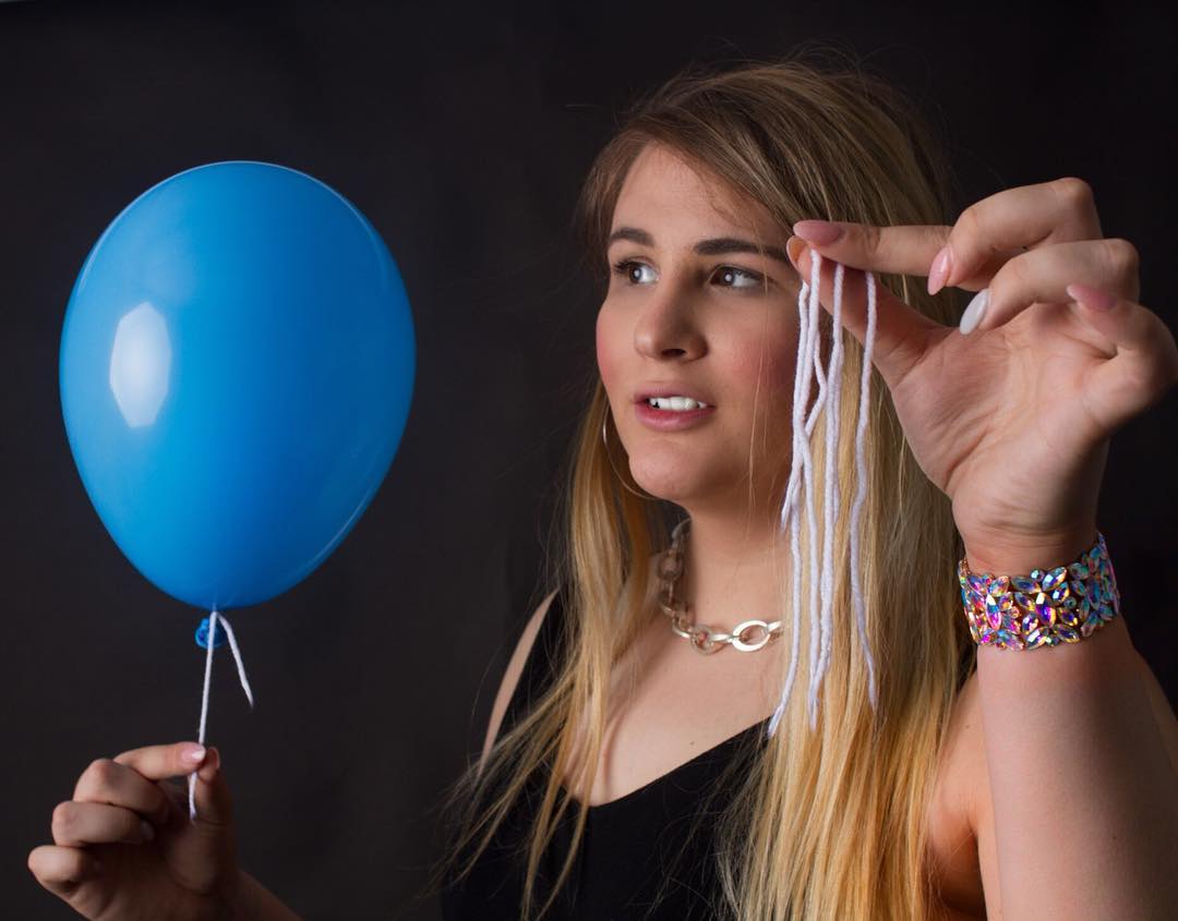 Magic Mikayla holding balloon and string