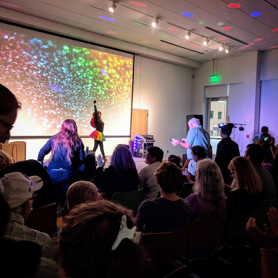 Performer and audience at Ames Public Library's All-Ages Drag Show