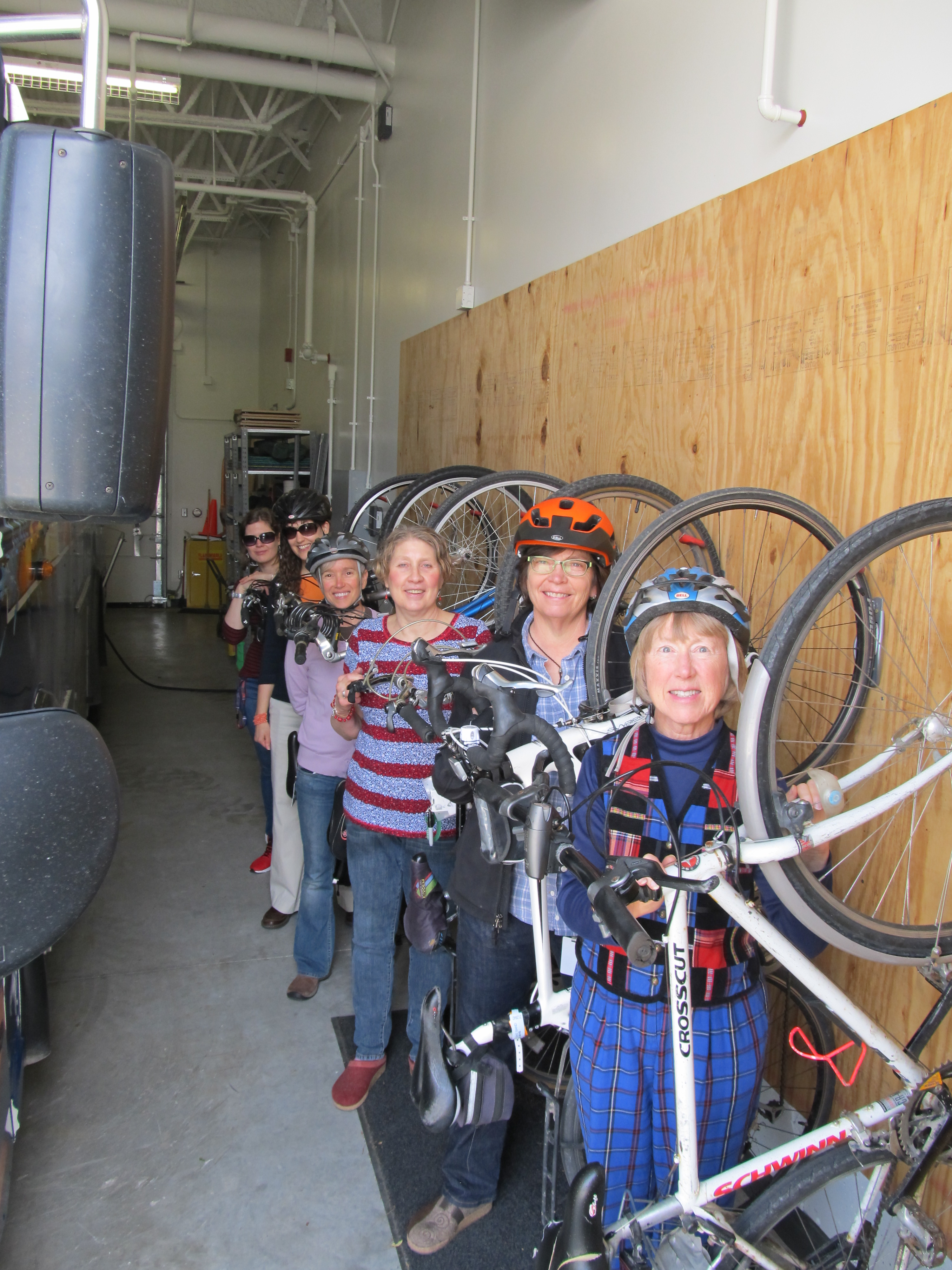 Bicycle commuters hanging bikes in garage