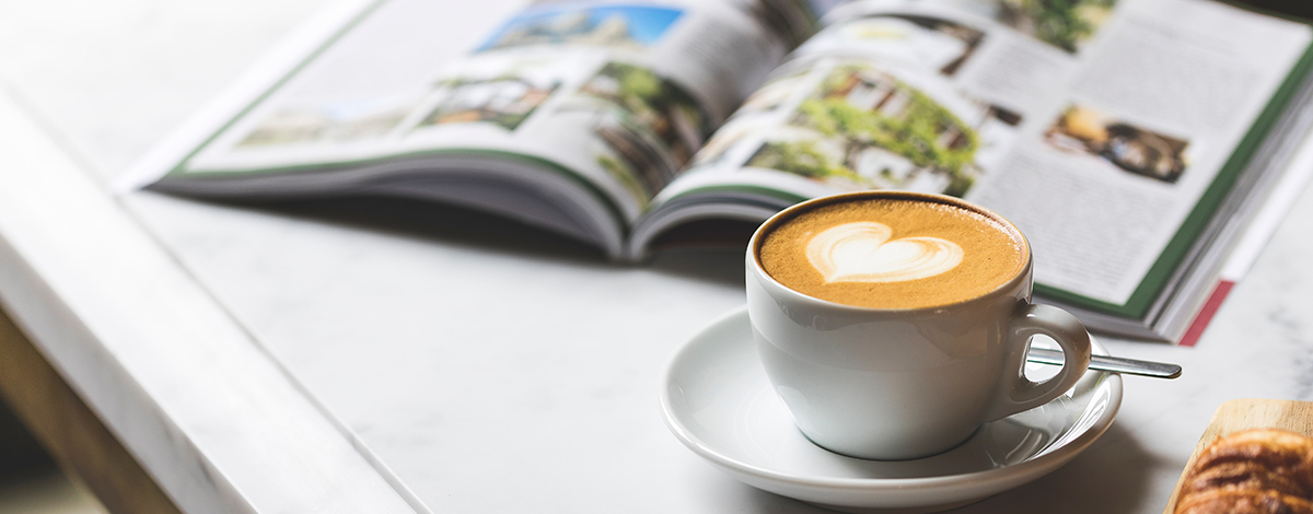 Coffee and open book on a desk