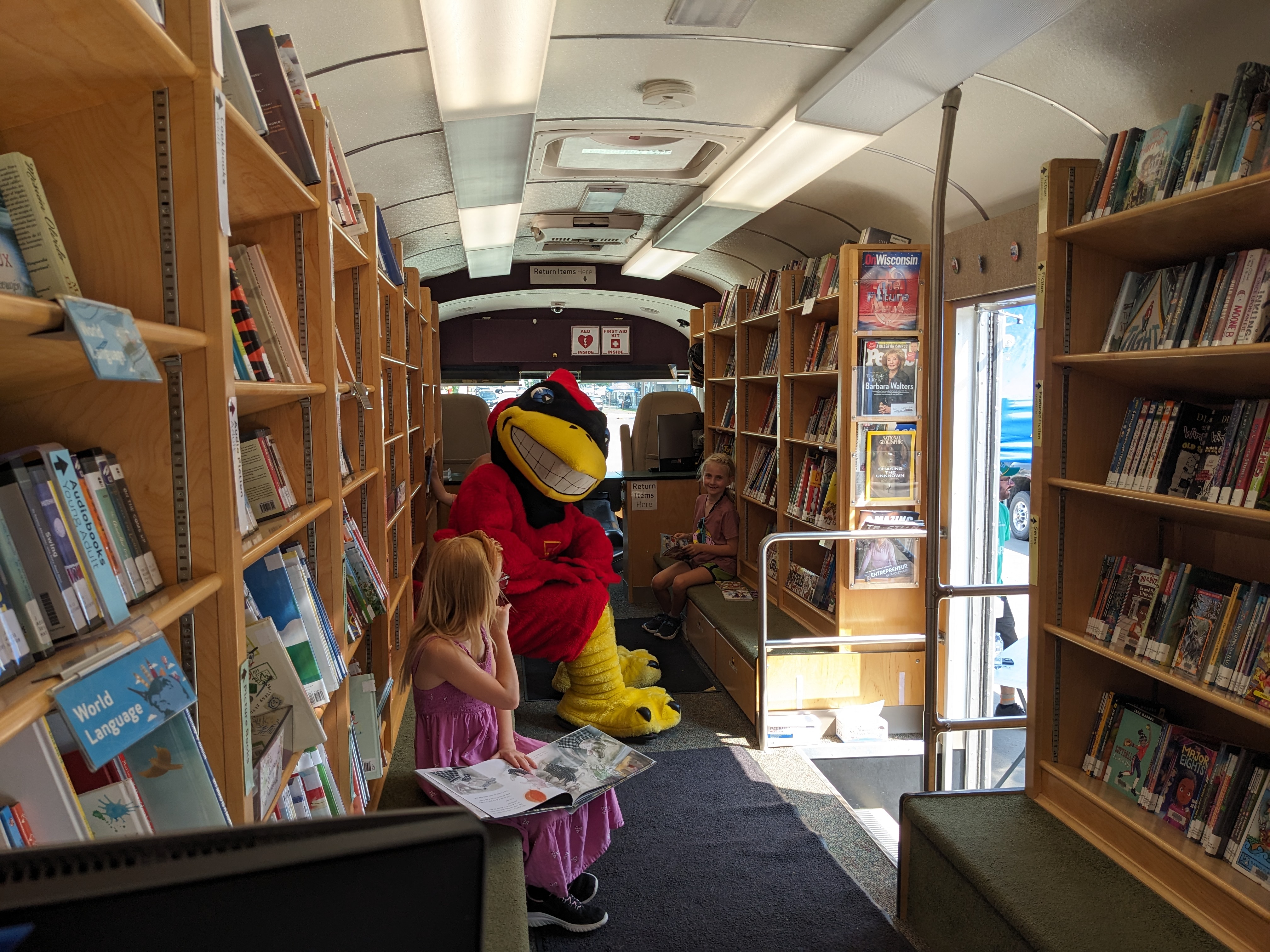 Cy and child reading on the Bookmobile
