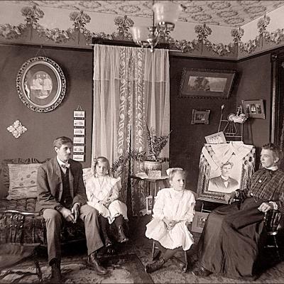 Antique photo of family sitting in home