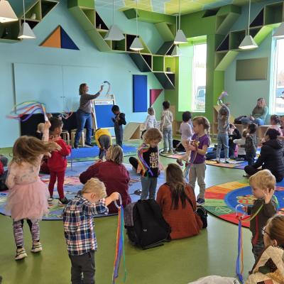Photo of families having fun at storytime in Ames Public Library's Storytime Room