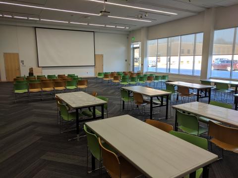Farwell T. Brown Auditorium with one side in auditorium style seating and the other in classroom style seating with a big screen at front of room