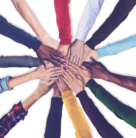 Many hands joined in center of image
