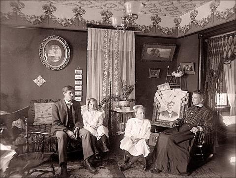 Antique photo of family sitting in home