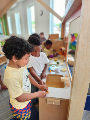 Children playing in play house at Ames Public Library