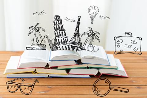 Photo of several books overlaid with illustrations of tourist destinations and travel icons