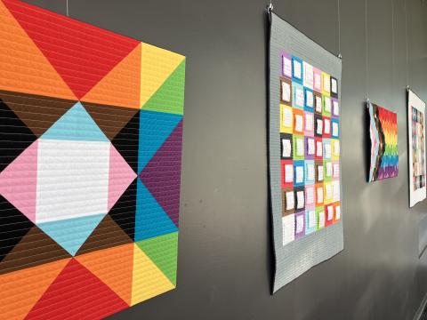 Photo of "Pride in Progress" exhibit featuring quilts by Ben Millet