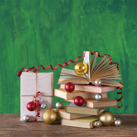 Stack of books and gifts with holiday decorations